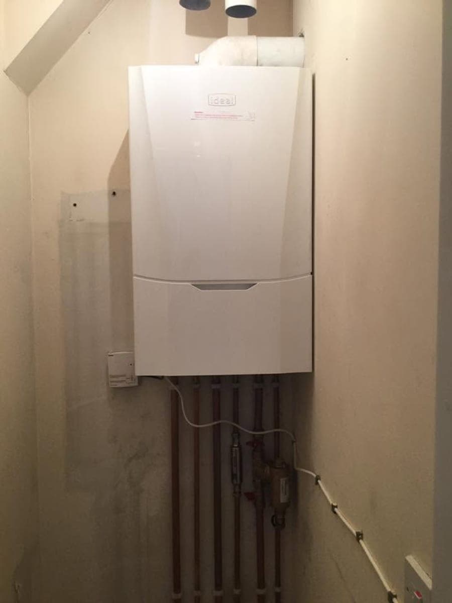 A newly fitted gas boiler with new copper pipework running below it