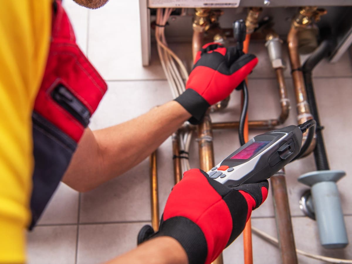 A heating engineer checking a gas boiler